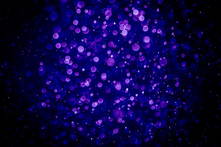 Blurred photo with purple violet and blue dots visible glittering, shining brightly look and feel luxurious Suitable for use as a wallpaperの写真素材