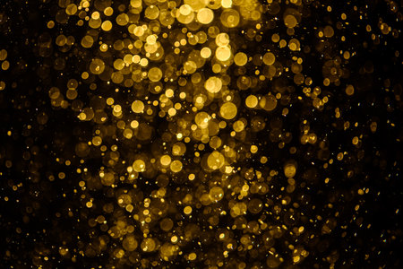 Blurred photo with golden dots visible glittering, shining brightly look and feel luxurious Suitable for use as a wallpaperの写真素材
