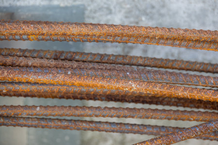 Close-up of a concrete foundation with a steel rebar cage inside, prepared for construction. Shows the initial stage of building supportの写真素材