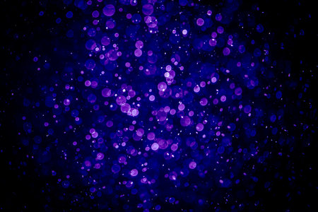 Blurred photo with purple violet and blue dots visible glittering, shining brightly look and feel luxurious Suitable for use as a wallpaperの写真素材