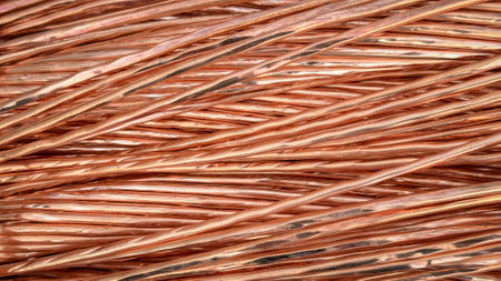 Interwoven copper wires showcasing complex twists and reflective textures.の写真素材