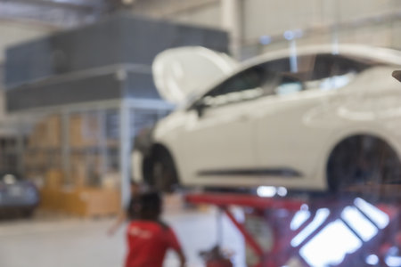 blured image of car service centre auto repair workshop use for backgroundの写真素材