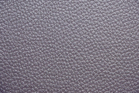 close-up of a soft Textured Purple Leather. The surface is covered in small, evenly spaced grains, giving it a smooth and luxurious appearance. The neutral color and natural texture make it a versatile backgroundの写真素材