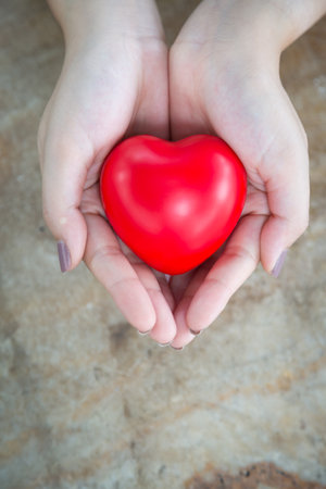 Woman hold red heartの写真素材