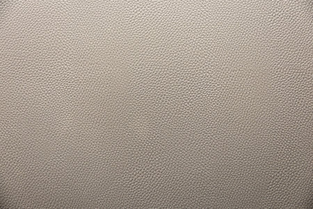 close-up shot of a fine-grained, grey leather texture. The image showcases the detailed pattern and subtle variations in color, making it suitable for a variety of design applications.の写真素材