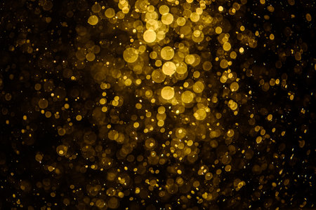 Blurred photo with golden dots visible glittering, shining brightly look and feel luxurious Suitable for use as a wallpaperの写真素材