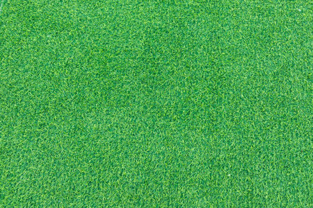 Close-up of lush green artificial grass with detailed texture and vibrant color.の写真素材