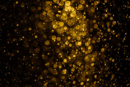 Blurred photo with golden dots visible glittering, shining brightly look and feel luxurious Suitable for use as a wallpaperの写真素材