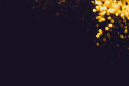 Gold bokeh from water of lights on black backgroundの写真素材