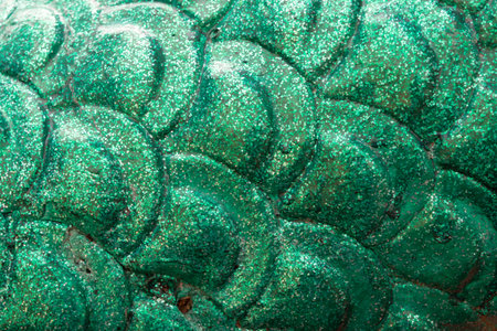 Close up of green metallic dragon skin texture background. Selective focus.の写真素材