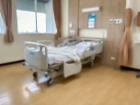 Blur image of Hospital bed in a luxurious and modern patient room. The atmosphere is clear and you can see the surrounding view. There are windows around the room.の写真素材