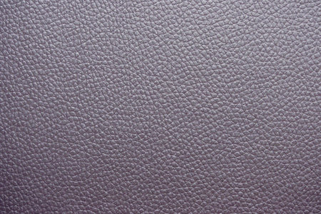 close-up of a soft Textured Purple Leather.  The surface is covered in small, evenly spaced grains, giving it a smooth and luxurious appearance. The neutral color and natural texture make it a versatile backgroundの写真素材
