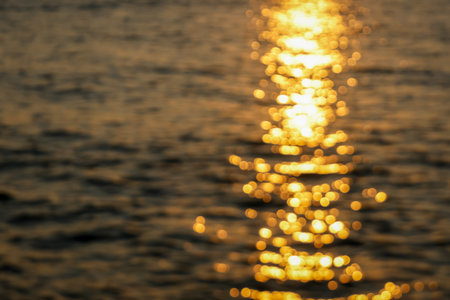blur background of sunset over the sea and bokeh lightの写真素材