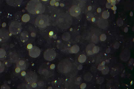 Black bokeh from water drops on black background, abstract textureの写真素材