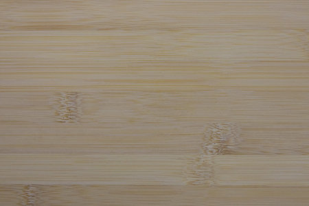 light-colored bamboo surface, showcasing its natural grain, nodes, and subtle linear texture.