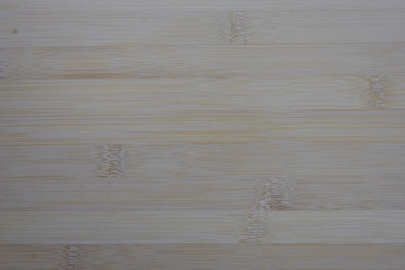 light-colored bamboo surface, showcasing its natural grain, nodes, and subtle linear texture.