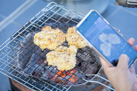 Sticky rice with egg and grilled over charcoal fireの写真素材