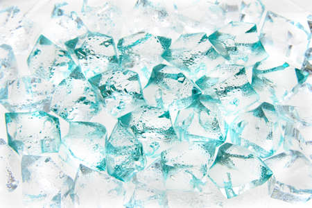 Wet pieces of glass of the different size with a turquoise shade