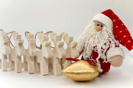 Toy Santa Claus with gifts and reindeers on the whiteの写真素材
