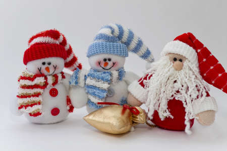 Rag snowmen and Santa Claus with a bag of gifts on the whiteの写真素材