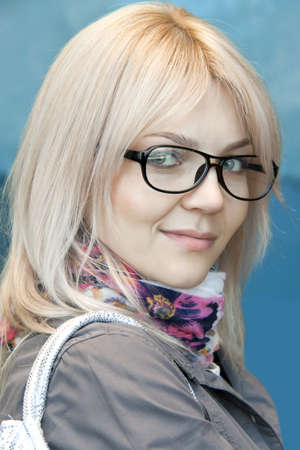 The woman in points and a handbag on a shoulder good-natured smilesの写真素材