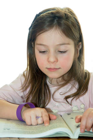 Child reads the book  Works over homework  On the whiteの写真素材