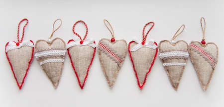 Hearts from a canvas on the white. A multi-coloured border. Day of Valentine. Toys on the Fur-treeの写真素材
