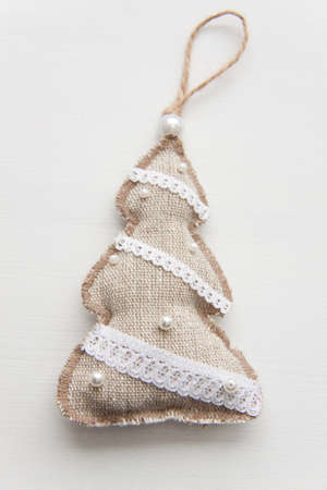 Fabric toy of a fur-tree on the white. An ornament for Christmasの写真素材