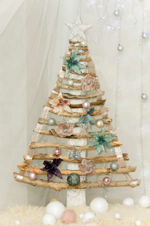 Creative fur-tree from sticks and boards for Christmas. Decorated fur-tree New Year's flower for New...