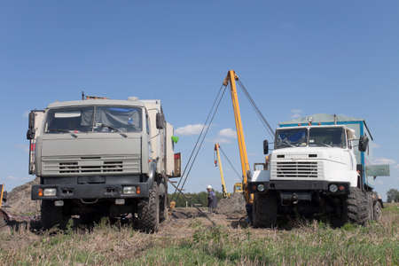 Trucks on excavation; pipe repairの写真素材