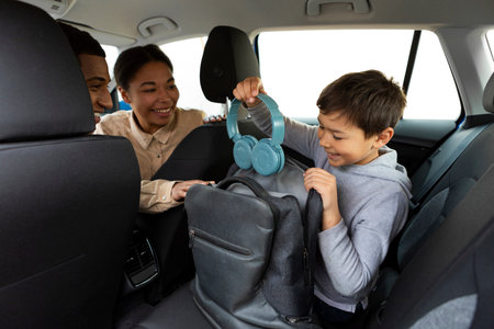 Preteen boy putting headphones in his backpack, parents turning back and looking at son, coming to...