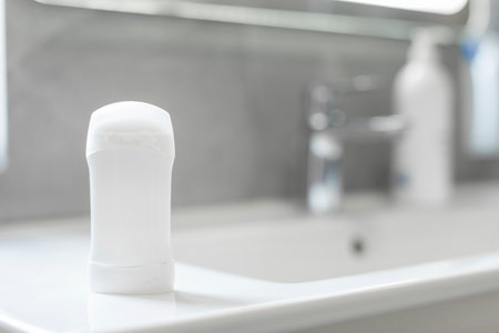 Blank stick deodorant on countertop in bathroom, mockup with copy space for brand designの写真素材