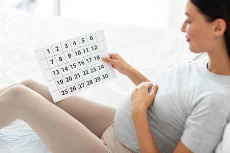 Holiday celebration. Loving young couple exchanging gifts, happy lady embracing present box, man and woman celebrating Christmas and New year at homeの写真素材