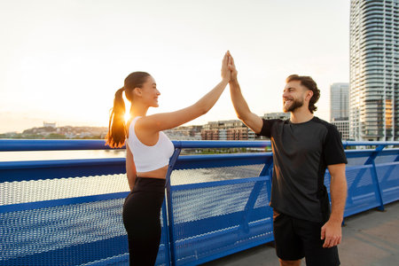 Couple giving high five for sport success and team support, celebrating achievement, winning...