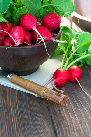 bunch of radishes on a wooden tableの写真素材
