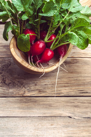 bunch of radishes on a wooden tableの写真素材
