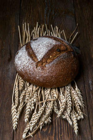 bread on the table with ears of wheatの写真素材