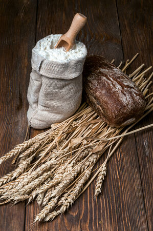 bread on the table with ears of wheatの写真素材