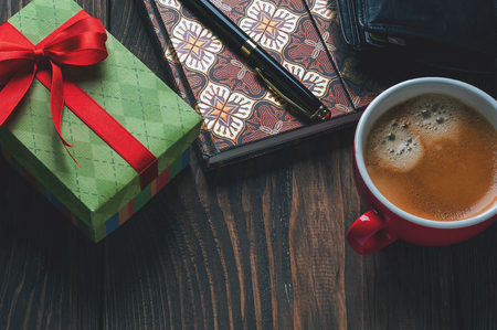 gift box and a cup of coffee on the tableの写真素材