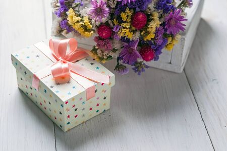 gift box and flowers on a light backgroundの写真素材
