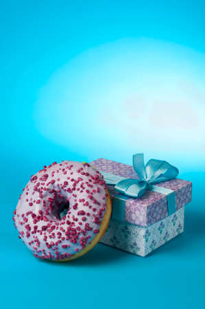 donut and gift on a blue backgroundの写真素材