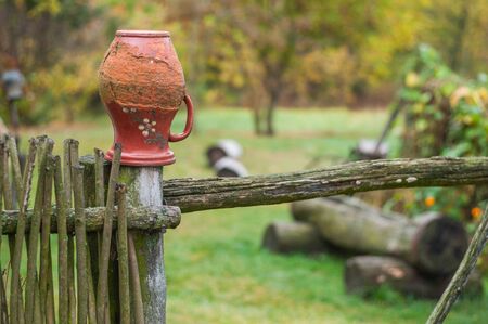 pitcher on wicker fenceの写真素材