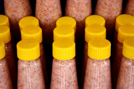 pink shrimp paste in yellow capped bottlesの写真素材