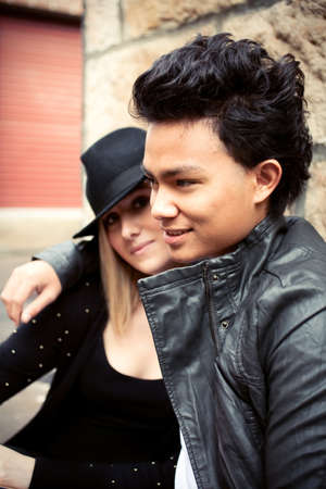 Young couples setting on the streetの写真素材