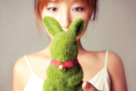 celebrate Easter, a girl holding a toy rabbit.