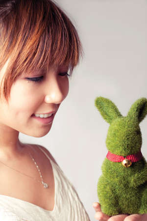 celebrate Easter, a girl holding a toy rabbit.の写真素材