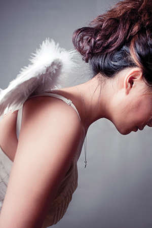 Girl wearing a white top with wings.の写真素材