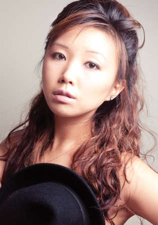 Asian young woman in black fashion shoot.の写真素材