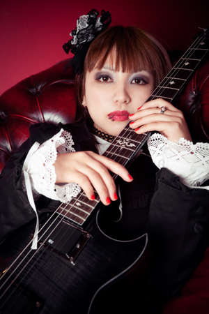 The gothic girl and her dark guitarの写真素材