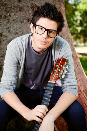 Young man playing guitarの写真素材